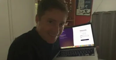 Ecommerce owner holding feedguardians on a laptop